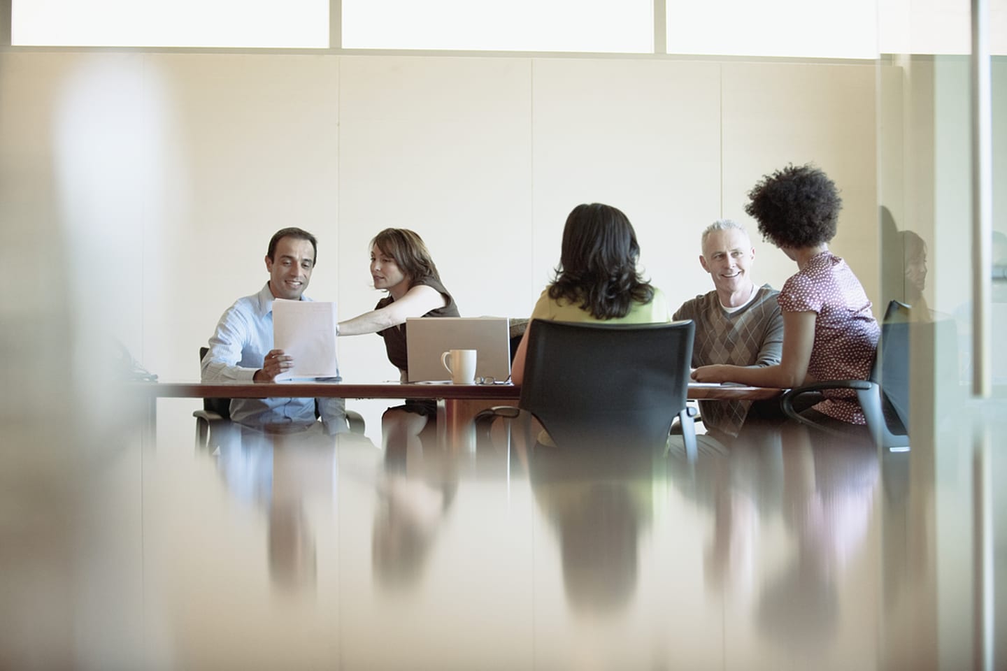 General Mills Brazil - Business professionals sitting at a conference table, engaged in a meeting